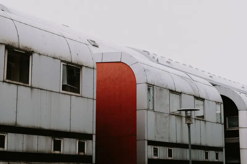 Industrial building with metal siding and a red rounded doorway