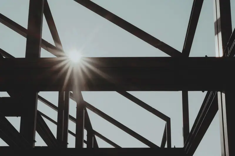 Steel framework silhouetted against the sun
